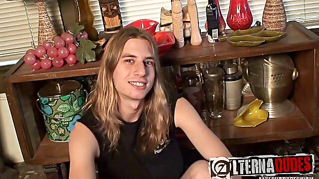 Gay guy with long dark blonde hair playing with his cock and asshole