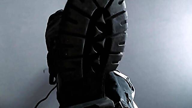 Feet fastened taut below coarse military boots