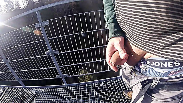 Im working on my foreskin cock outside on a very public observation tower by a river.