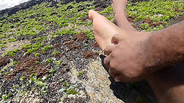 Massaging my feet on the beach